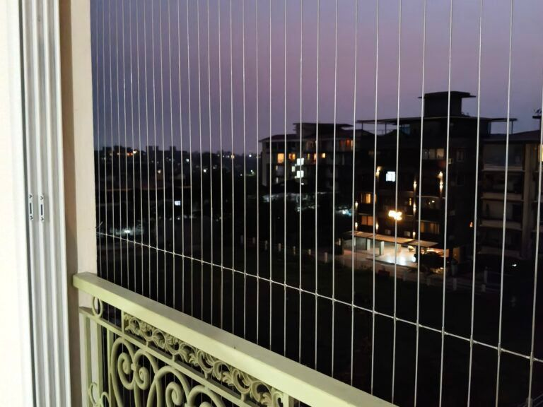 Invisible grill installation on apartment balcony